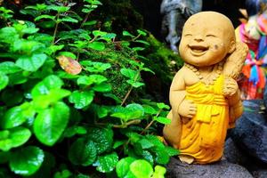 Old Cute Monk Statue be left in the Park. photo