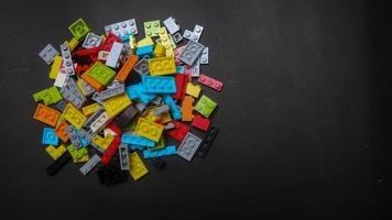 Plastic toy block on a black background photo