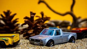 Minahasa, Indonesia  saturday, December 2022, a toy car among the pinecones photo