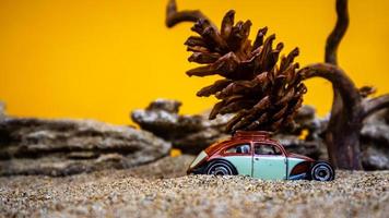 toy car hauling pinecones on an orange background photo