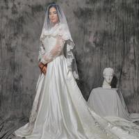 portrait of a girl in a wedding dress on a gray background photo