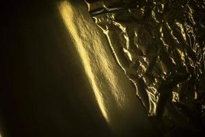 Golden texture. Plastic film. Golden wave. photo