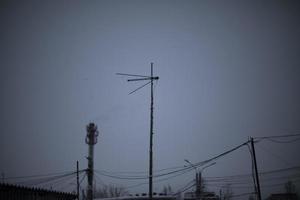 Wires on pole. Electrical wires on background of gray sky. Depressing look. photo