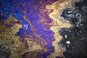 Spot gasoline. Puddle of fuel. Acid colors. photo