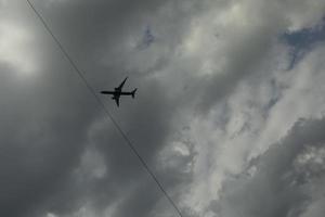 Airplane among clouds. Air transport in sky. Flight details. photo