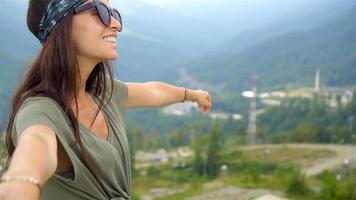 Beautiful happy young woman in mountains in the background of fog video