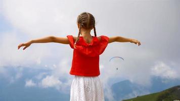 Beautiful happy little girl in mountains in the background of fog video