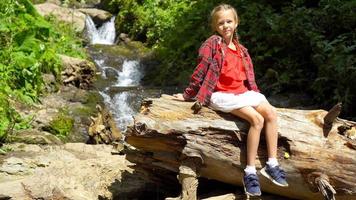 Little girl enjoying view of waterfall in Krasnay Poliana video