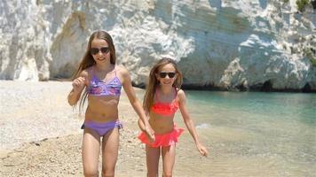 Little girls having fun at tropical beach during summer vacation video