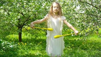 Adorable little girl in blooming apple garden on beautiful spring day video