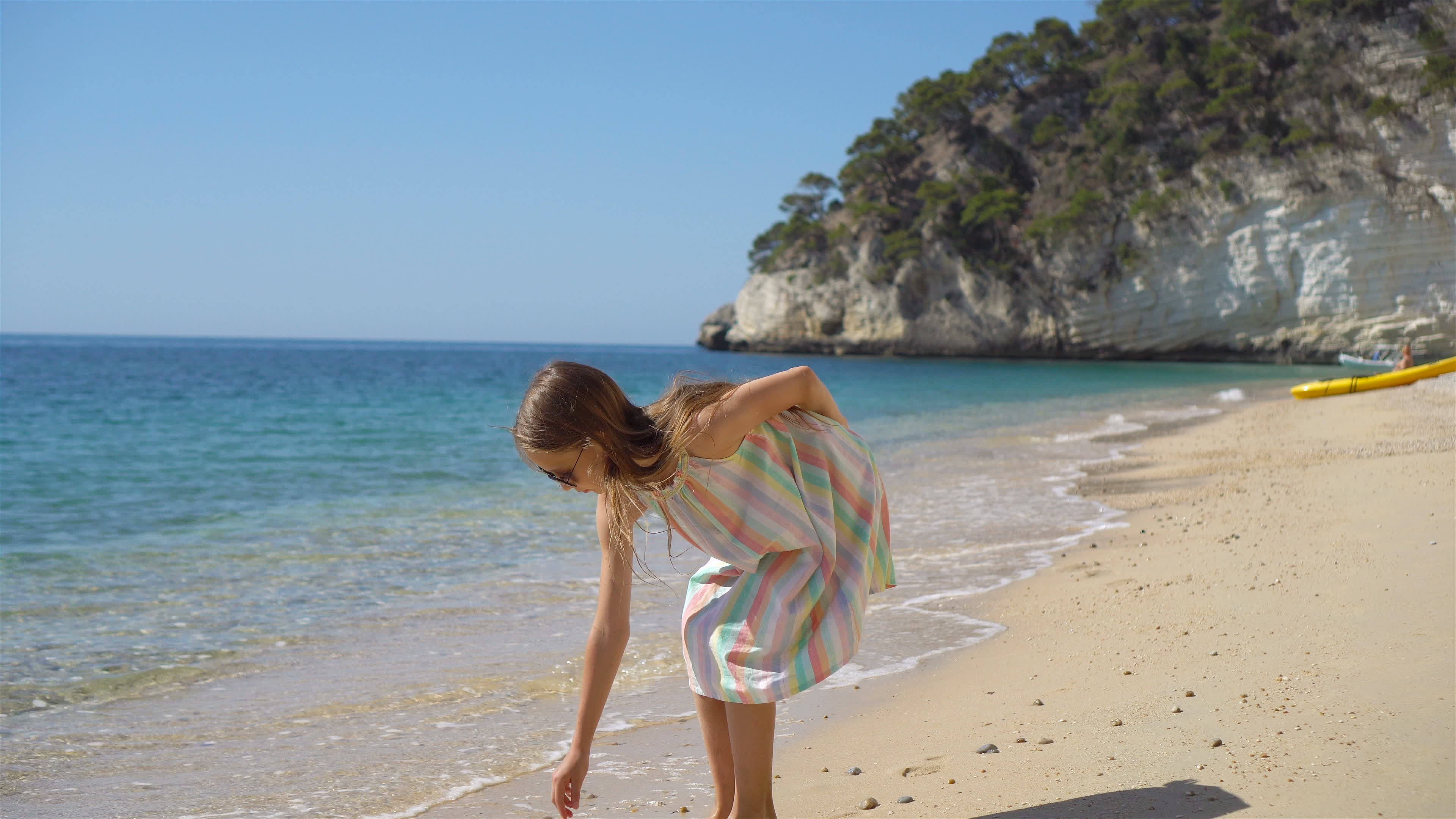 Beautiful little girl in dress at beach having fun. Funny girl enjoy summer vacation. 19795807 Stock Video at Vecteezy Beautiful little girl in dress at beach having fun. Funny girl enjoy summer vacation. 19795807 Stock Video at Vecteezy