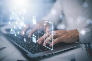 Businessman working on laptop with virtual screen. Online documentation database, IT consultant being set up Virtual Document Management System with laptop,Software for archiving corporate files. photo