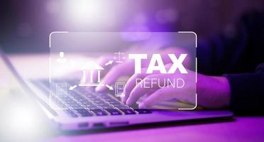 Concept TAX-2023 and refund tax of duty taxation business, graphs, and chart being demonstrated on the screen media, App for selecting tax refund, Keeping track of annual tax expenditures photo