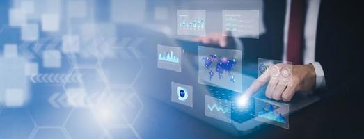 Businessman interacting with laptops, phones, and tablets with featuring stock tickers or graphs, cryptocurrency and new trading platforms, ideas and perspectives, Stock investment,New technology photo