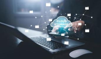 Businessman hand holding smartphone and laptop with cloud computing diagram show on hand. Cloud technology. Data storage. Networking and internet service concept, Cloud sharing download and upload photo
