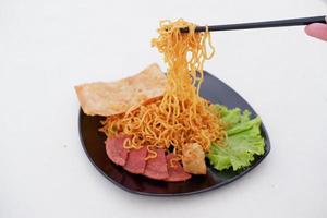 fried noodle crackers with sliced meat and vegetables photo