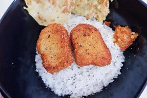 rice with chicken nuggets and side dishes photo