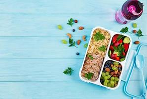 Lunch box  meatloaf, bulgur, nuts, cucumber  and berry. Healthy fitness food. Take away. Lunchbox. Top view photo