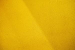 Yellow Concrete Wall Background with Natural Light Beam and Shadow. photo