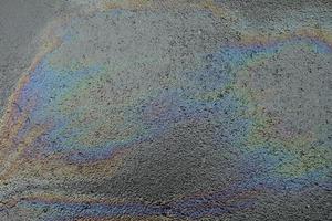 Oil Spill on Asphalt Road Background. photo