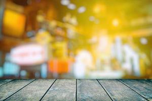 Wood Table with Blurred Coffee Shop Background, Suitable for Product Display and Business Concept. photo