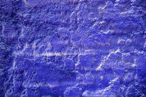 Blue Spray Painting on Stucco Wall Texture Background. photo