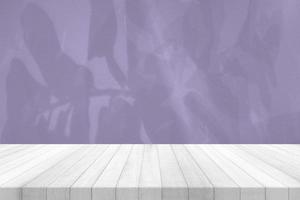 White Wood Table with Leaves Shadow on Digital Lavender Concrete Wall Texture Background, Suitable for Healthy Product Presentation, Backdrop, Display, and Mock up. photo