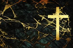 Golden Jesus Christ Crucifix Cross on Dark Grunge Stone Wall Background, Suitable for Christian or Catholic Religion Concepts. photo