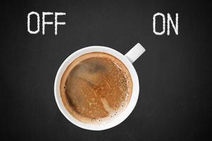 Cup of Coffee on Chalkboard with Off and On Text. photo
