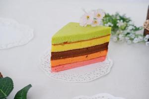 delicioso arco iris pastel rebanada como un antecedentes foto