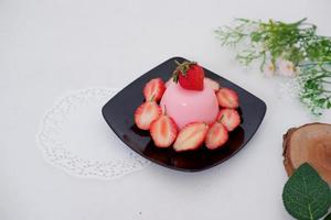 Pudding with delicious strawberries as a background photo