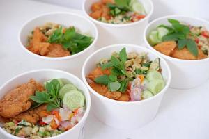 rice with chicken and vegetables in a cup photo