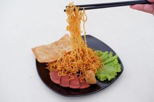 fried noodle crackers with sliced meat and vegetables photo