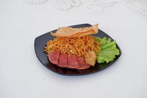 fried noodle crackers with sliced meat and vegetables photo