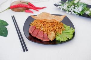 fried noodle crackers with sliced meat and vegetables photo