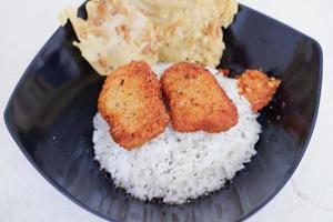 rice with chicken nuggets and side dishes photo