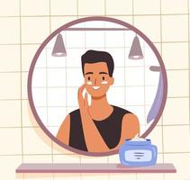 Skincare routine concept. Man applying face cream in bathroom. Happy young guy looking at mirror vector