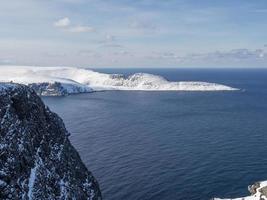 Snowy peninsula and cliffs at North Cape, Norway photo