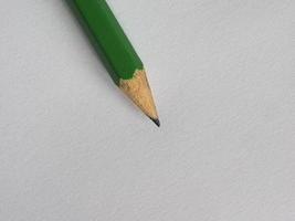 green pencil on paper sheet desk photo