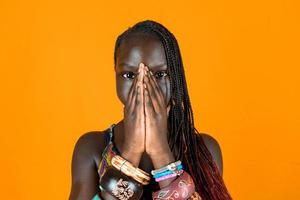 portrait of beautiful African teen with ethnic bracelets and pigtails. photo