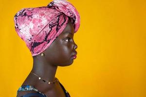 portrait of african female teen with colorful ethnic scarf on head photo