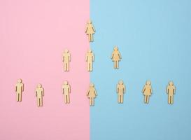 wooden figures on a blue pink background, hierarchical organizational structure of management, effective management model in the organization photo