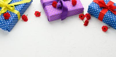 boxes are packed in holiday paper with polka dots and tied with a silk ribbon on a background, birthday gift, surprise photo