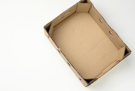 rectangular empty cardboard box of brown paper on a white background, box without a lid for vegetables and fruits in with holes photo