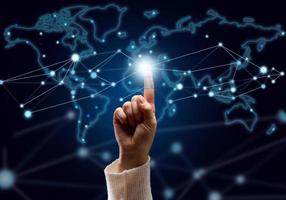 female hand presses on the connection point and holographic global network with connections. Internet communications, wireless connection, distribution point photo