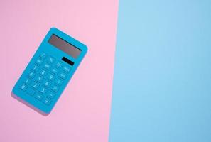 Blue plastic calculator on a blue background, top view photo