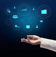 Control and management of business processes in the enterprise for efficient operation and increased profits. Concept with manager's hand and gears on holographic screen photo