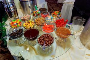 Candies in glass jars in candy shop photo