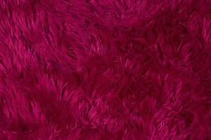 Dark burgundy fur texture with long pile. photo