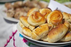 On a plate are yeast buns sprinkled with sugar. photo